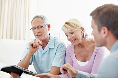 Buy stock photo Notebook, meeting and financial advisor with old couple in home for retirement plan, wealth management and profit. Insurance payout, budget and broker with senior man and woman for joint account