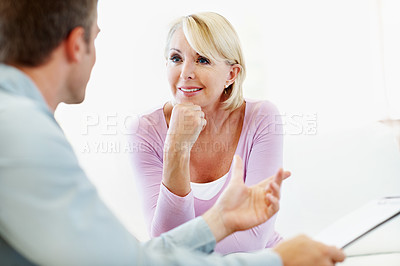 Buy stock photo Happy woman, listening and financial advisor with document in meeting, discussion or savings update. Wealth management, consultant and chat with mature person, advice and estate planning with report