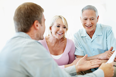 Buy stock photo Old couple, financial advisor and document in home for retirement meeting, deal and planning. Senior man, happy woman and paperwork for pension fund, loan agent or budget for asset management