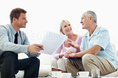 Buy stock photo Elderly couple, financial advisor and document in home for pension meeting, deal and planning. Senior man, happy woman and paperwork for retirement fund, loan agent or budget for asset management