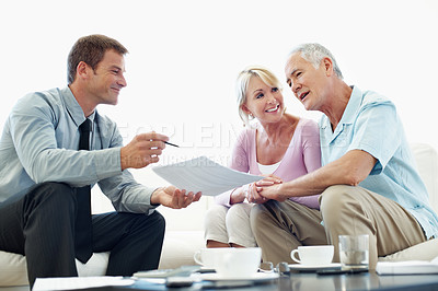 Buy stock photo Happy, old couple and financial advisor with document in home, chat or listen to retirement strategy. Senior people, meeting and estate planning with wealth manager, explaining and paperwork in house