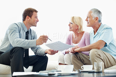 Buy stock photo Old couple, talk and financial advisor with document in home, happy or listen to retirement strategy. Senior people, meeting and estate planning with wealth manager, explaining and paperwork in house