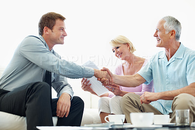 Buy stock photo Handshake, consultant and senior couple in home for trust agreement, asset transfer and approval. Retirement, financial advisor and people shaking hands for fiduciary duty, fraud protection and happy