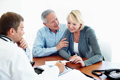 Buy stock photo Doctor, documents and consultation with senior couple, insurance or medical aid benefits. Healthcare coverage, happy people and consent form in studio, retirement or results on white background