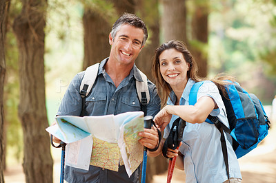 Buy stock photo Map, portrait or happy couple with hiking navigation for outdoor destination or route in nature. Man, woman or hikers with tour guide or trip for trekking path, direction or travel together in forest