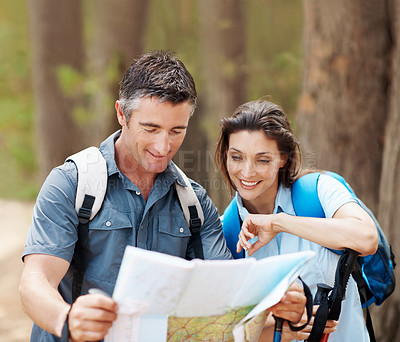 Buy stock photo Map, forest and happy couple with hiking guide for outdoor navigation, destination or route. Man, woman or hikers with document or plan for trekking path, direction or travel together in wilderness
