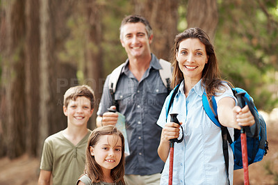 Buy stock photo Hiking, happy and portrait of family outdoor for adventure, exploring or bonding on holiday. Nature, support and parents with children in forest for trekking on vacation, getaway or weekend trip.