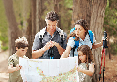 Buy stock photo Map, hiking and family with navigation in forest for outdoor destination or route in nature. Dad, mom or children checking tour guide for trekking path, direction or travel together in wilderness