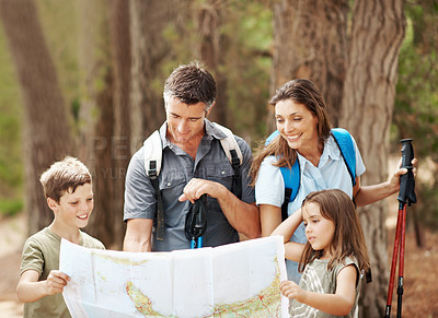 Buy stock photo Map, hiking and family with navigation in nature for outdoor destination or route in forest. Dad, mom or children checking tour guide for trekking path, direction or travel together in wilderness
