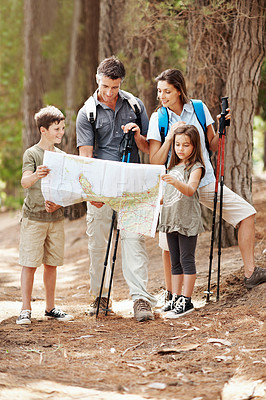 Buy stock photo Map, hiking and happy family with navigation in nature for outdoor destination or route in forest. Dad, mom or children checking tour guide on trip for trekking path, direction or travel together