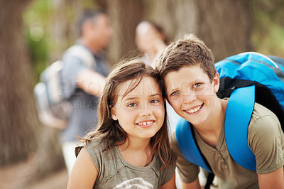 Buy stock photo Portrait, hug and children in forest for hiking, travel adventure and outdoor with family. Parents, siblings and happy boy with girl embrace for fresh air, trekking and bonding on weekend in nature