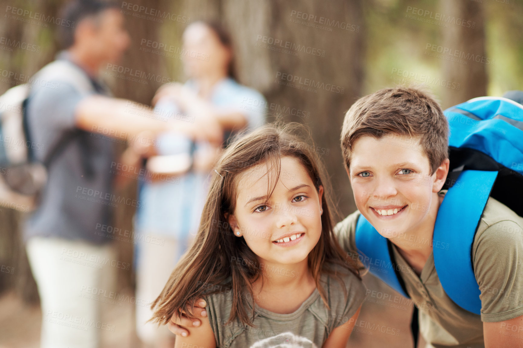 Buy stock photo Portrait, hug and kids in forest for hiking, travel adventure and outdoor with family. Parents, siblings and happy boy with girl embrace for fresh air, trekking and bonding on weekend in nature