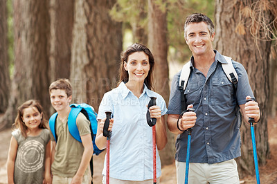 Buy stock photo Hiking, travel and portrait of family outdoor for adventure, exploring or bonding on holiday. Happy, nature and parents with children in forest for trekking on vacation, getaway or weekend trip.