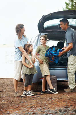 Buy stock photo Happy, family and camping with car in nature for travel, roadtrip or outdoor holiday together. Children, mom and dad unpacking vehicle with gear for adventure, sightseeing or bonding in wilderness
