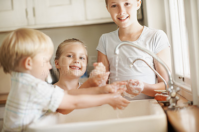 Buy stock photo Happy, portrait and kids in bathroom washing hands for hygiene, wellness and cleaning with siblings. Smile, home and girl with children by sink for soap, foam and disinfection for germ prevention