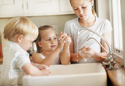 Buy stock photo Sink, water and children in house, washing hands and siblings with soap for germ removal in kitchen. Kids, self care and bacteria prevention with tap liquid, disinfection and family hygiene in home