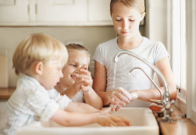 Buy stock photo Sink, self care and children in kitchen, washing hands or siblings with soap for bacteria prevention. Happy kids, cleaning and germ removal with tap water, disinfection and family hygiene in house