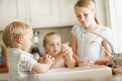 Buy stock photo Sink, water and children in kitchen, washing hands and siblings with soap for germ removal in house. Kids, self care and bacteria prevention with tap liquid, disinfection and family hygiene in home