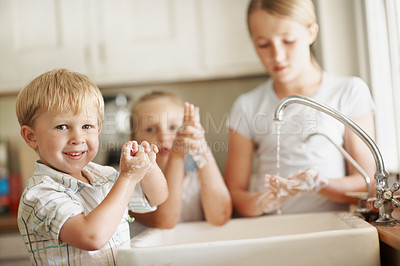 Buy stock photo Children, portrait and boy in bathroom washing hands for hygiene, wellness and cleaning with siblings. Smile, home and child with family by sink for soap, foam and disinfection for germ prevention