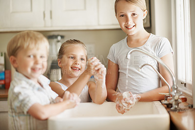 Buy stock photo Portrait, siblings and children in bathroom washing hands for hygiene, wellness and cleaning together. Smile, home and girl with family by sink for soap, foam and disinfection for germ prevention
