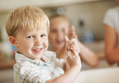 Buy stock photo Health, happy child and washing hands in house portrait for hygiene, learning self care or wellness. Skincare, kid and cleaning with soap in family home for germ safety, sanitation and healthy habit