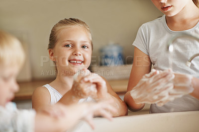 Buy stock photo Happy, portrait and children in bathroom washing hands for hygiene, wellness and cleaning with siblings. Smile, home and girl with family by sink for soap, foam and disinfection for germ prevention
