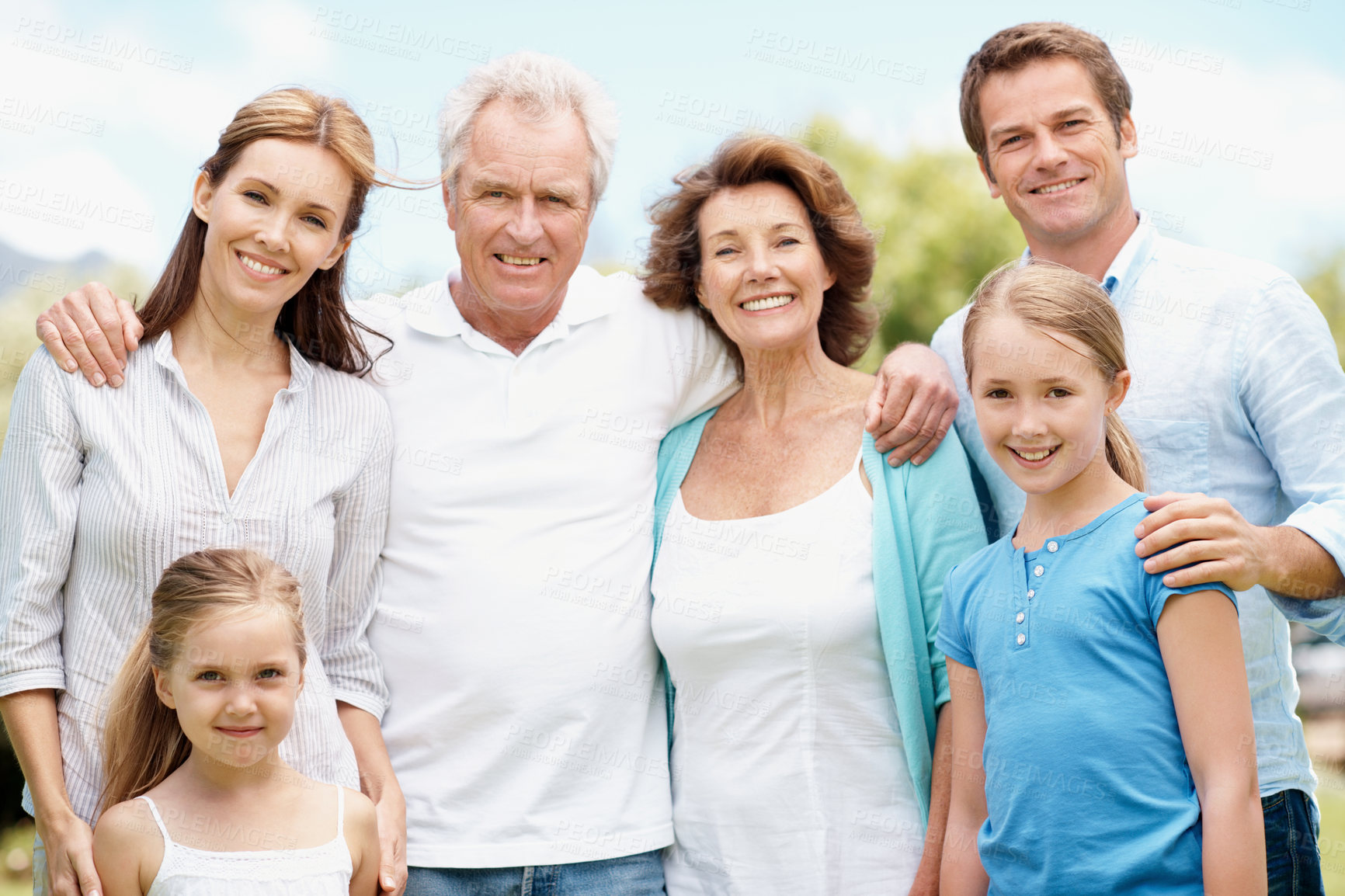 Buy stock photo Happy, family and bonding with children at park, generations and reunion with grandparents on break. Outdoor, senior people and parents with kids on weekend, portrait and relax with smile in nature
