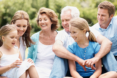 Buy stock photo Grandparents, parents and kids outdoor with laugh, generations together and funny joke for bonding. Happy family, senior people and children relax with humor for connection, good mood and wellness.