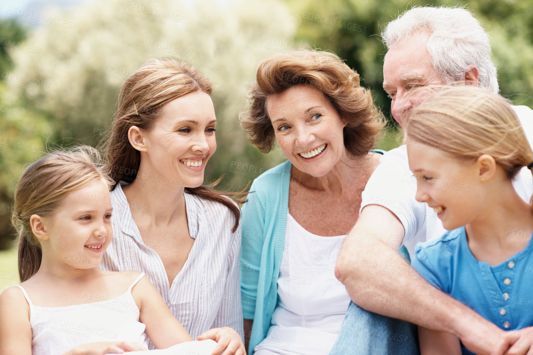 Buy stock photo Grandparents, parents and children in park for bonding, connection and relax together on weekend. Happy, generations and girls with mom, dad and senior people for picnic, laugh and embrace for love