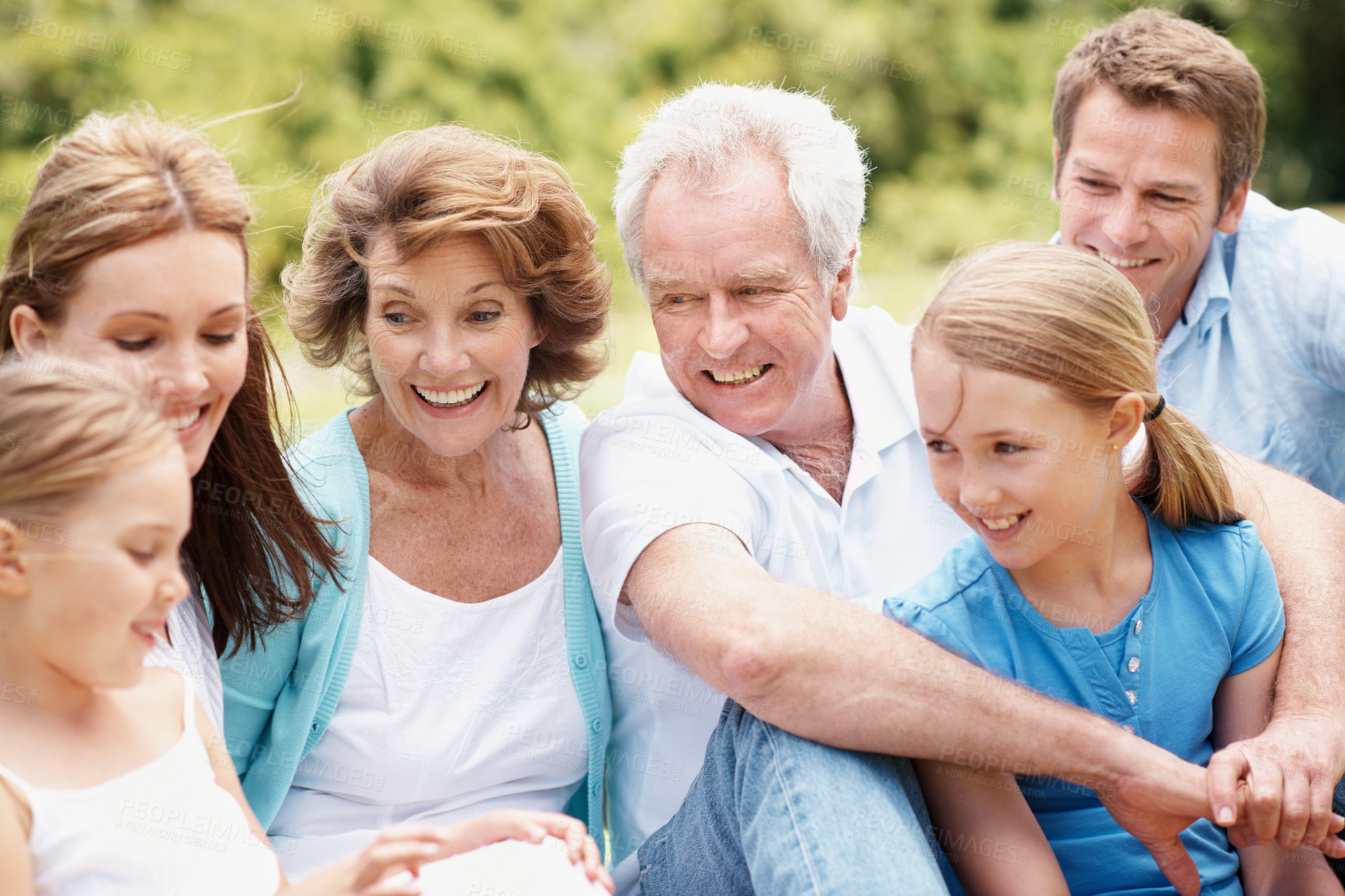 Buy stock photo Grandparents, parents and children in garden for bonding, connection and relax together on weekend. Happy, generations and girls with mom, dad and senior people for picnic, laugh and embrace for love