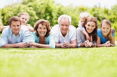Buy stock photo Portrait, family and parents outdoor with kids, relax together or generations bonding on weekend break. Space, happy mature people and grandma on grass with grandfather, children or rest for wellness