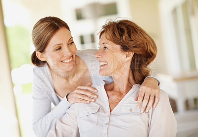 Buy stock photo Hug, care and smile with senior mother and woman in home for bonding, support and love. Family visit, connection and happy with people in apartment for weekend break, trust and embrace together