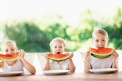 Buy stock photo Bite, portrait and children with watermelon in backyard for healthy snack, food and eating in summer. Family, siblings and kids with fruit for wellness, diet and nutrition for weekend outdoor