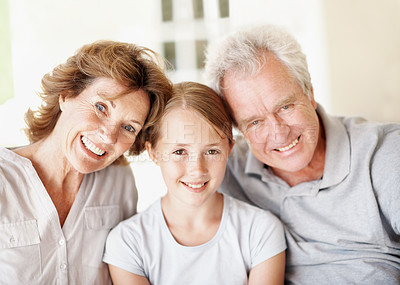 Buy stock photo Grandparents, kid and smile portrait in home for bonding together, holiday visit and security. Happy, senior people and grandchild with love in house for weekend stay, family connection and support