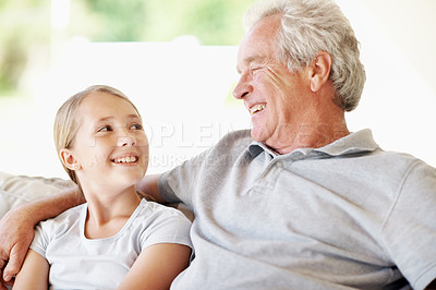 Buy stock photo Relax, laugh and grandfather with child on sofa in home for bonding, support and connection. Love, family visit and weekend break with senior man and kid in apartment for trust, funny joke and care