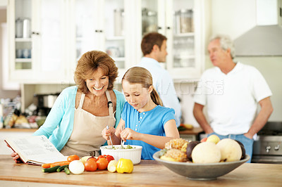 Buy stock photo Cooking, recipe and grandma with child in house, connection and learning culinary skills in kitchen. Happy, senior woman and meal prep with girl, family bonding and kid with healthy food in home