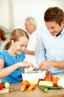 Buy stock photo Father, kid and cooking in kitchen with family gathering, smile or vegetables for healthy nutrition. Happy, man and daughter in home with meal prep, food ingredients or learning for child development