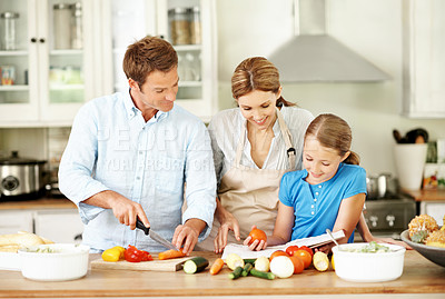 Buy stock photo Parents, child and cooking in kitchen with recipe book, help and chop vegetables for healthy nutrition. Happy, mother and father in house with daughter, food ingredients or instructions for meal prep
