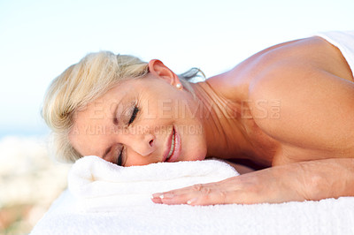 Buy stock photo Senior woman, sleeping and massage table at resort, holistic healing and luxury treatment on holiday. Zen, spa and mature person with smile on break, stress relief and happy on vacation and wellness