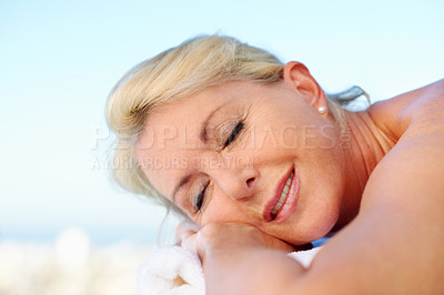 Buy stock photo Senior woman, sleeping and massage table at spa, holistic healing and luxury treatment for body care. Resort, stress relief and mature person with smile on break, zen and happy on holiday or wellness