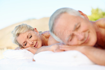Buy stock photo Spa, couple and senior woman on massage table, peaceful vacation and luxury treatment for body care. Resort, stress relief and old people with smile on break, zen and happy on holiday and wellness