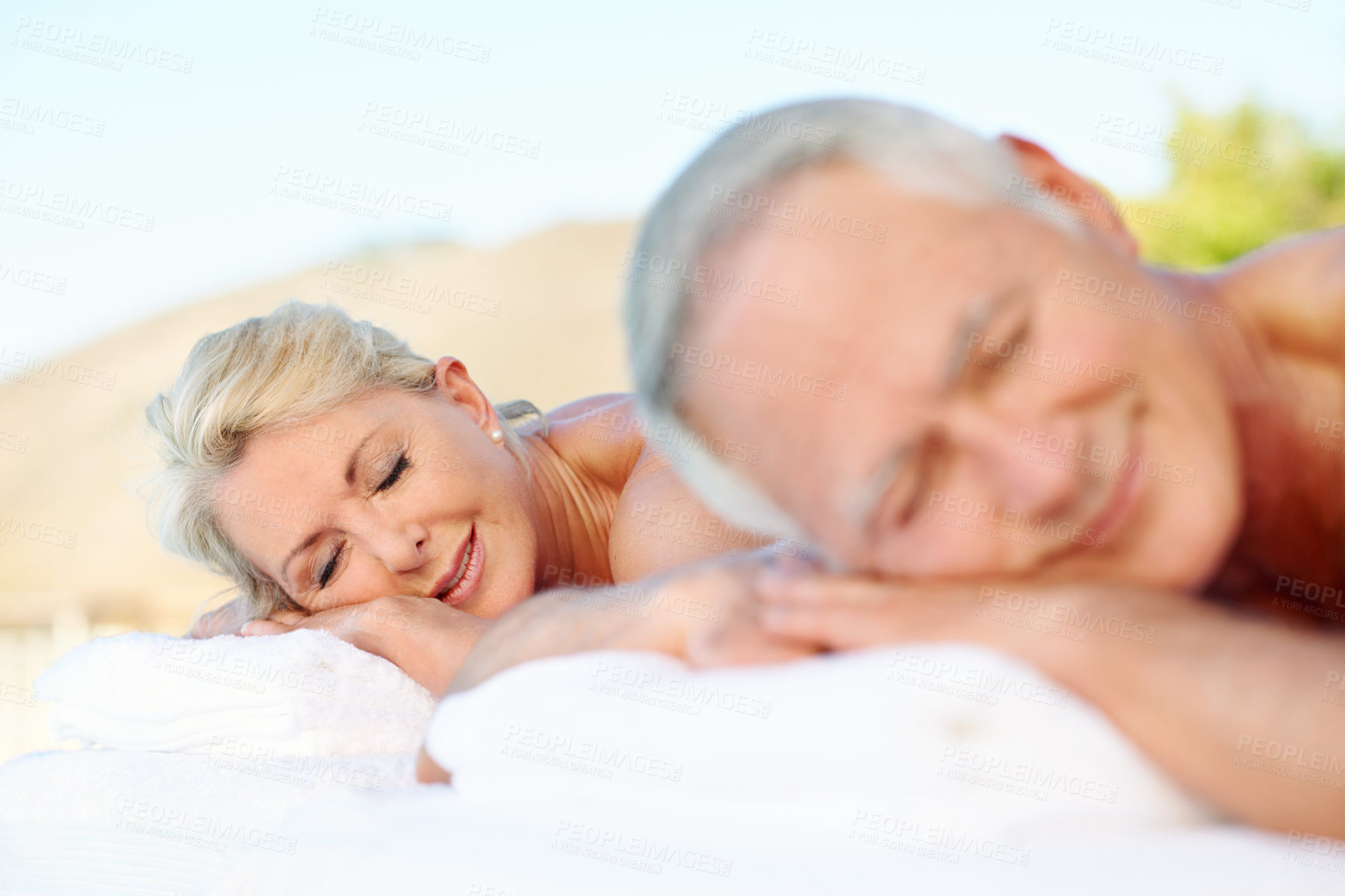 Buy stock photo Spa, couple and senior woman on massage table, peaceful vacation and luxury treatment for body care. Resort, stress relief and old people with smile on break, zen and happy on holiday and wellness