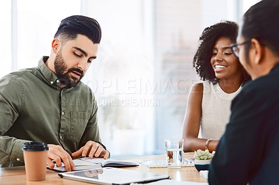 Buy stock photo Shot of a group of young businesspeople having a meeting in a modern office