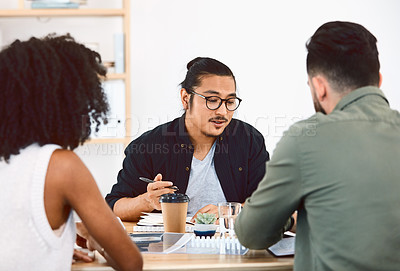 Buy stock photo Shot of a group of young businesspeople having a meeting in a modern office
