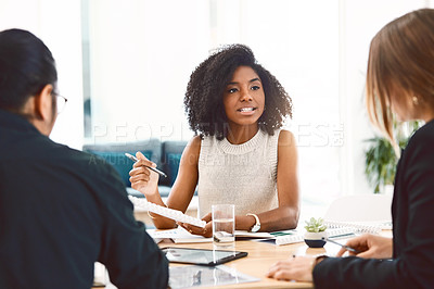 Buy stock photo Shot of a group of young businesspeople having a meeting in a modern office
