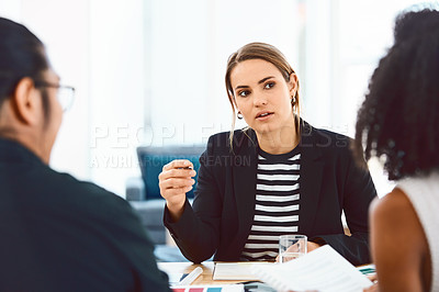 Buy stock photo Shot of a group of young businesspeople having a meeting in a modern office
