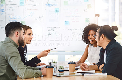 Buy stock photo Shot of a group of young businesspeople having a meeting in a modern office
