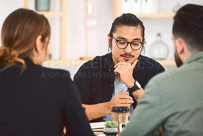 Buy stock photo Shot of a group of young businesspeople having a meeting in a modern office