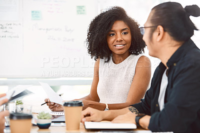 Buy stock photo Shot of a young businessman and businesswoman having a meeting in a modern office