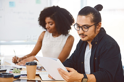 Buy stock photo Shot of a young businessman and businesswoman having a meeting in a modern office